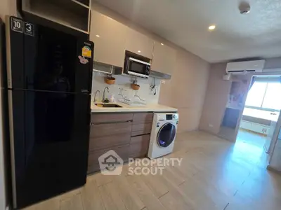 Modern kitchen with sleek appliances and open layout in a stylish apartment.