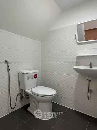 Modern bathroom with sleek white tiles and contemporary fixtures