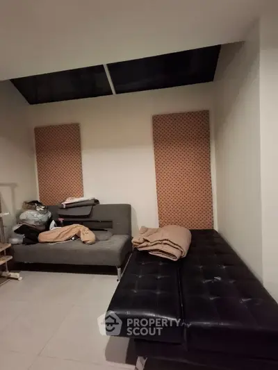 Cozy interior room with modern furniture and skylight, ideal for relaxation or study.