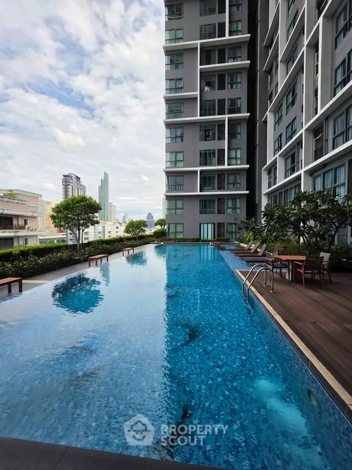 Luxurious high-rise apartment with stunning rooftop pool and city views.