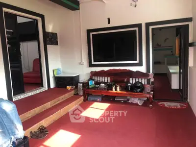 Charming interior with red carpet and wooden bench, ideal for cozy gatherings.