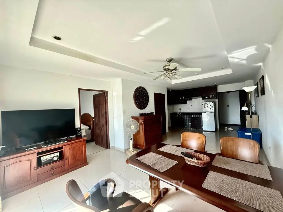 Spacious open-plan living and dining area with modern kitchen and natural light.