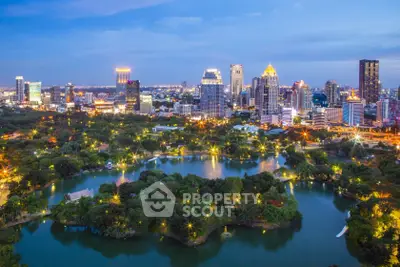 Stunning cityscape view with lush park and skyline at dusk, showcasing urban living and natural beauty.