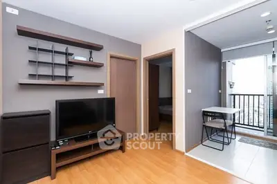 Modern living room with open balcony and stylish shelving in a contemporary apartment.