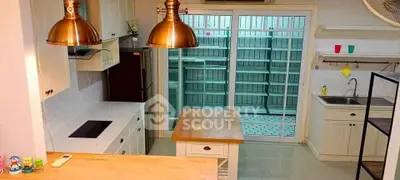 Charming kitchen with open layout and modern appliances, featuring a cozy island and ample storage space.
