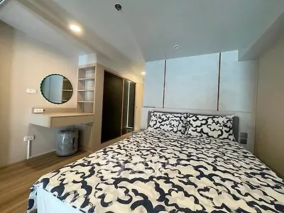 Modern bedroom with stylish decor and built-in storage in a contemporary apartment.