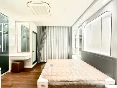 Luxurious modern bedroom with elegant decor and ample natural light