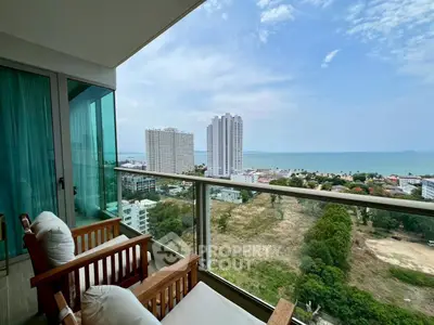 Stunning balcony view with ocean and cityscape, perfect for relaxation and enjoying the scenery.