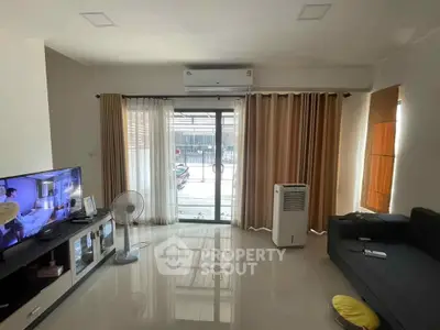 Spacious living room with modern decor and large windows for natural light.