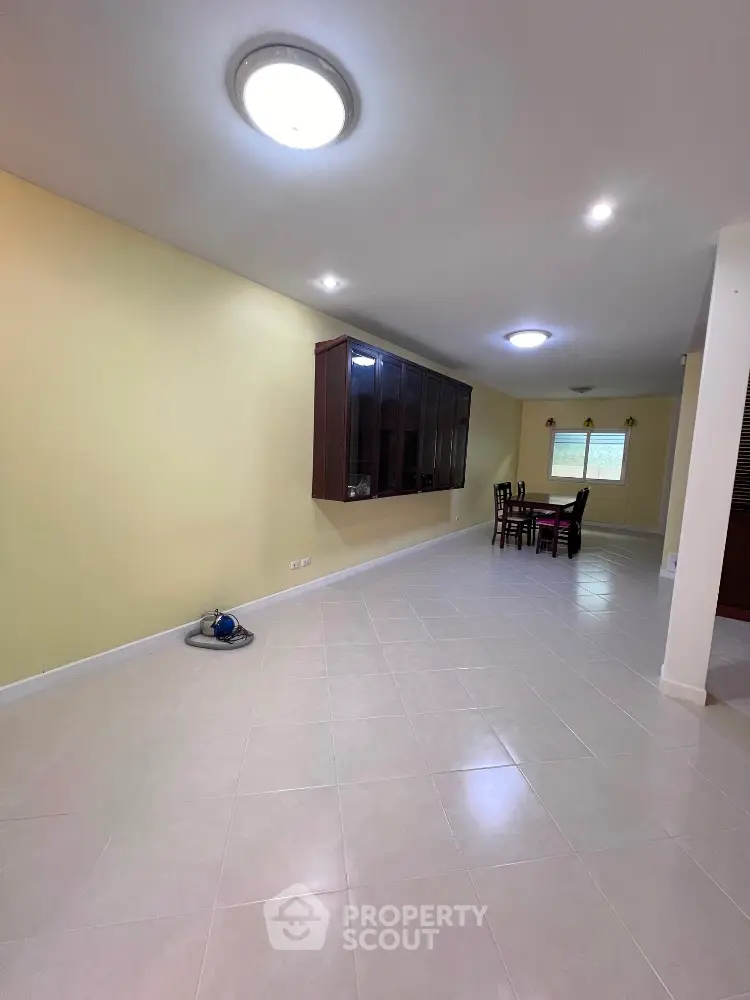 Spacious open layout living area with dining set and wall-mounted cabinet