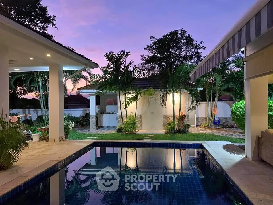 Luxurious tropical villa with private pool and lush garden at sunset