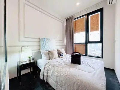 Modern bedroom with large windows and stylish decor in a high-rise apartment.