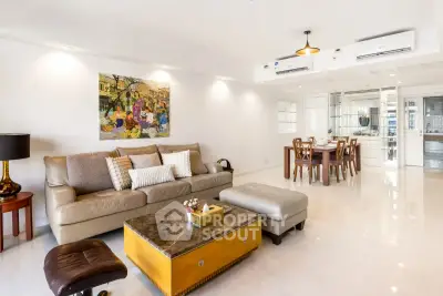 Spacious modern living room with elegant decor and dining area, perfect for family gatherings.