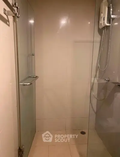 Modern shower area with glass doors and sleek fixtures in a contemporary bathroom.