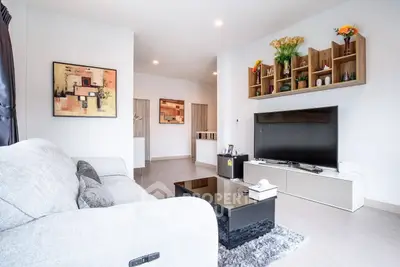 Modern living room with stylish decor and large flat-screen TV