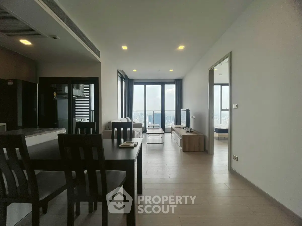 Spacious modern living room with open layout and stunning city view, perfect for urban living.