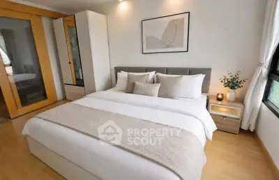 Elegant bedroom with modern decor and cozy ambiance, featuring a large bed and stylish furnishings.