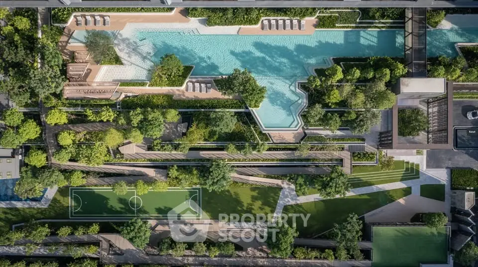 Stunning aerial view of luxury residential complex with pool and landscaped gardens.