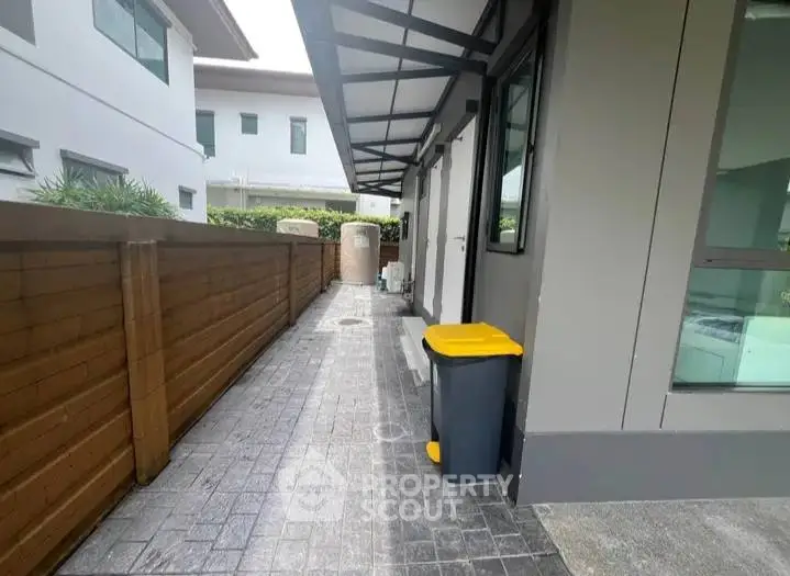 Modern exterior walkway with sleek design and wooden fence
