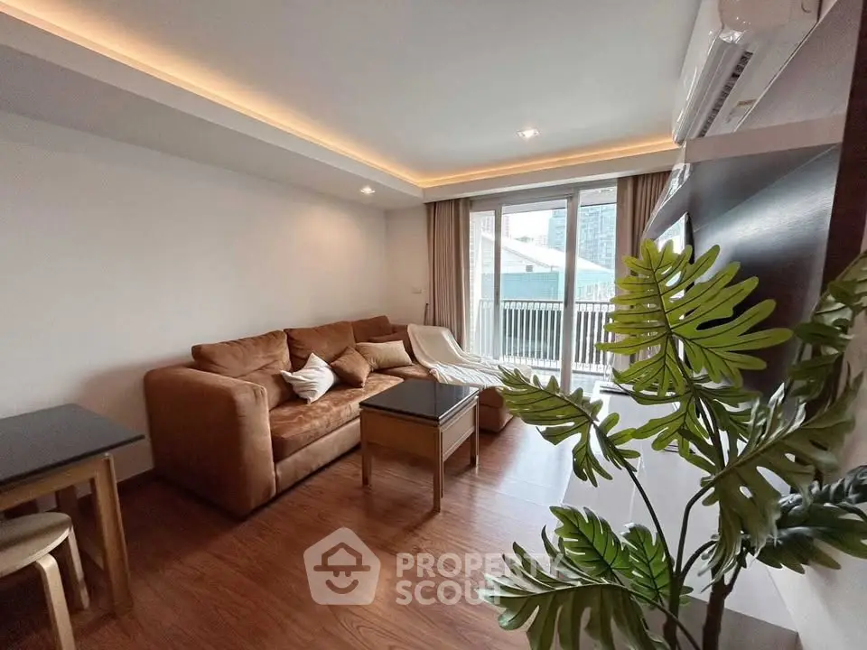 Modern living room with cozy sofa and balcony view in stylish apartment