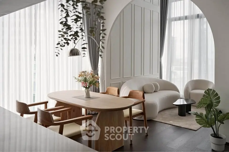 Elegant modern living room with stylish furniture and large windows, perfect for urban living.
