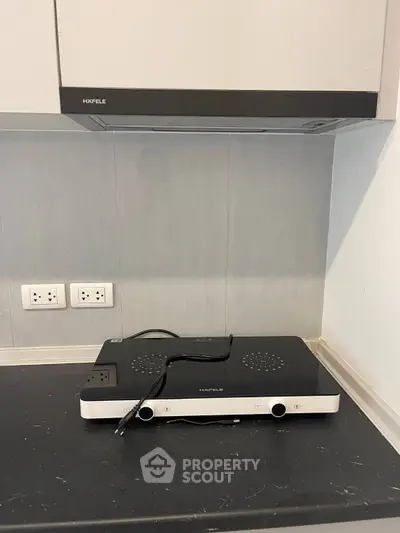 Modern kitchen with sleek black countertop and built-in stove