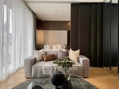 Luxurious modern living room with elegant decor and floor-to-ceiling windows.