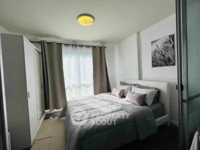 Cozy bedroom with modern decor and ample natural light