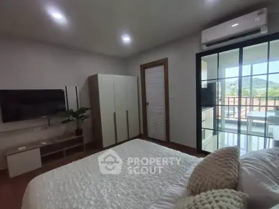 Cozy bedroom with modern decor and balcony view