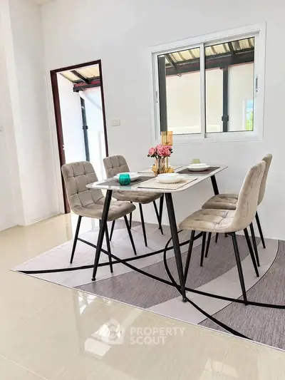 Modern dining area with stylish table and chairs, bright natural light, and elegant decor.