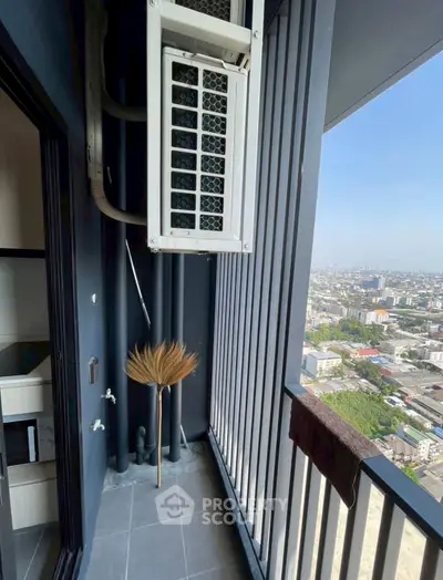 High-rise balcony with city view and air conditioning unit, perfect for urban living.