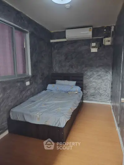 Cozy bedroom with modern air conditioning and stylish decor, perfect for comfortable living.