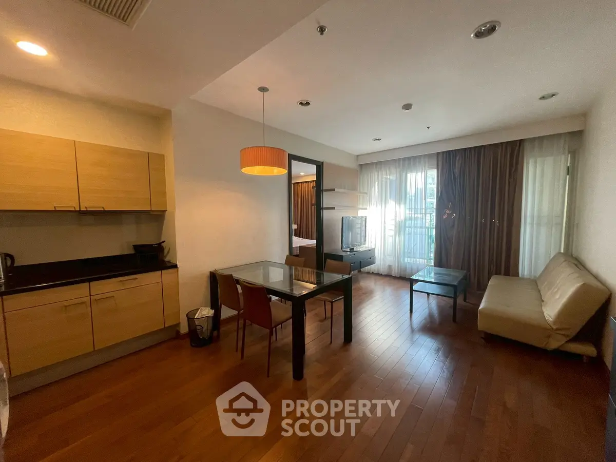 Spacious open-plan living room with modern kitchen and cozy seating area.