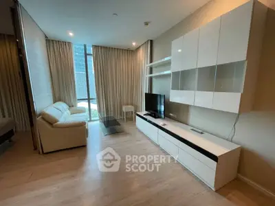 Modern living room with sleek furniture and large window offering city view