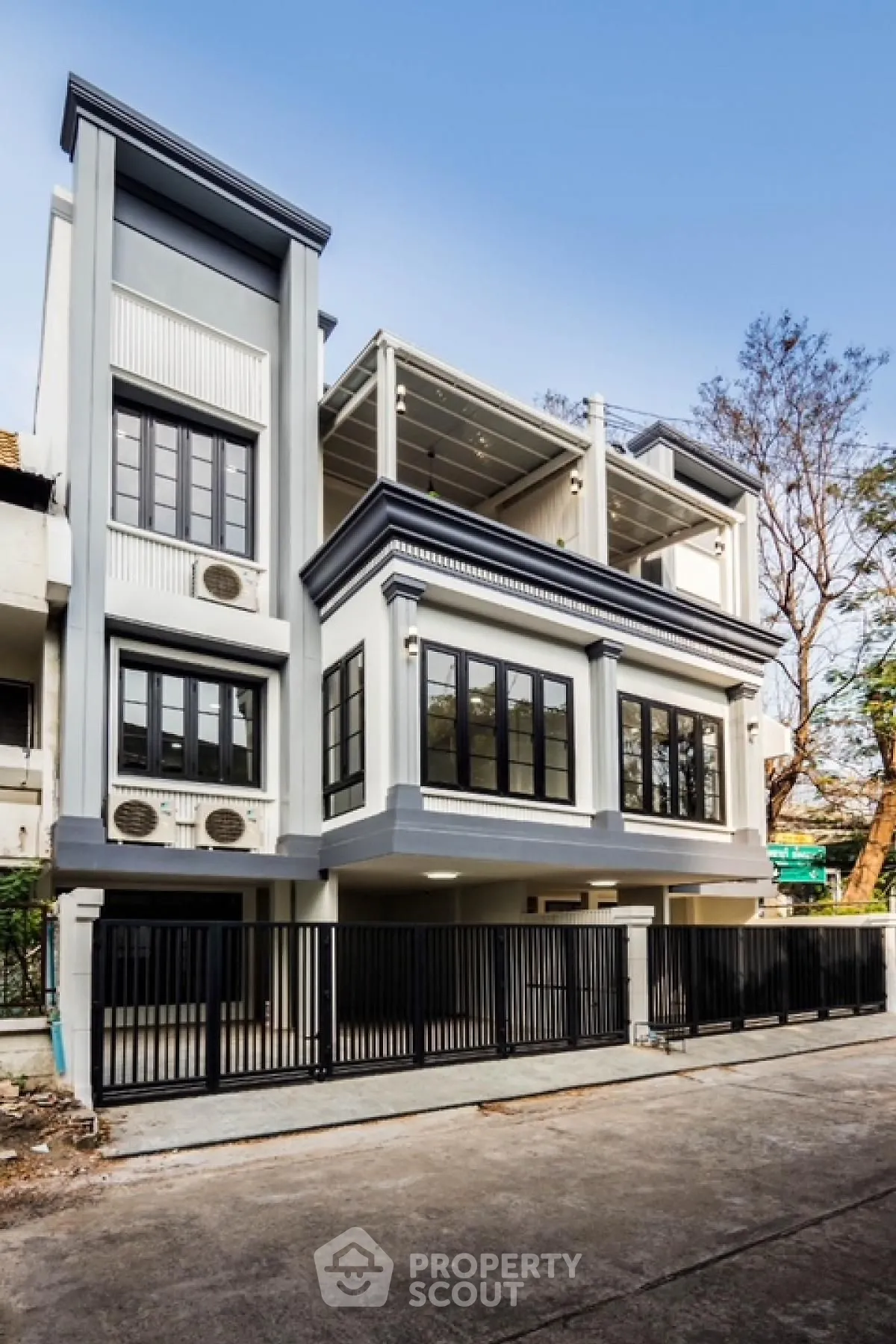 Stunning modern townhouse with sleek design and spacious balconies in urban setting.