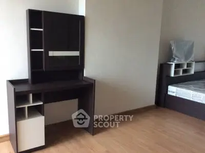 Modern bedroom with sleek furniture and wooden flooring, perfect for a minimalist lifestyle.