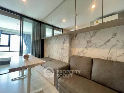 Modern living room with marble accent wall and cozy seating area