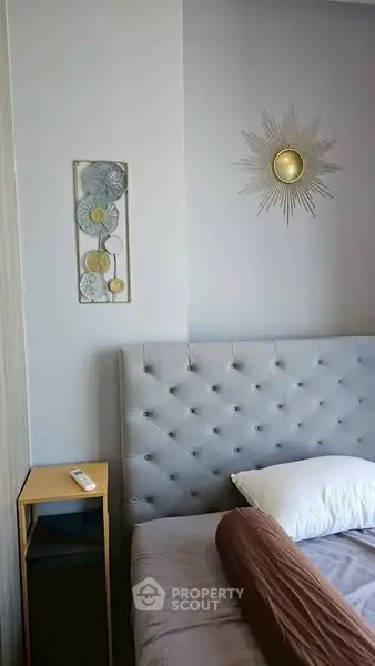 Modern bedroom with stylish decor and tufted headboard