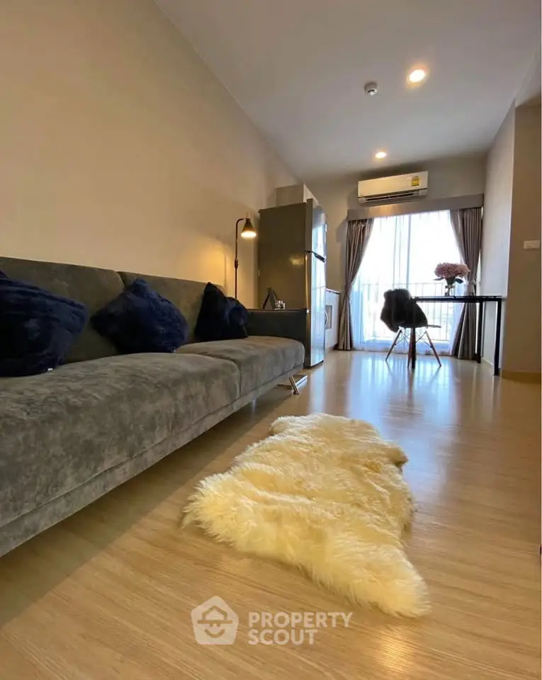 Modern living room with stylish decor and large window for natural light