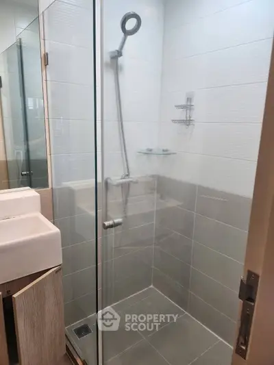 Modern bathroom with glass shower enclosure and sleek fixtures
