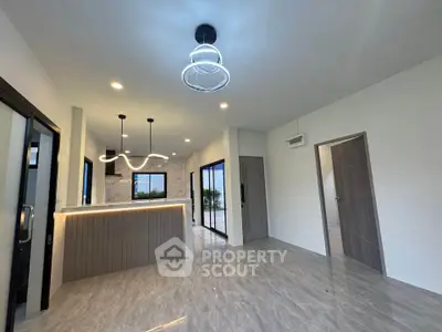 Modern open-plan living room with stylish lighting and marble flooring