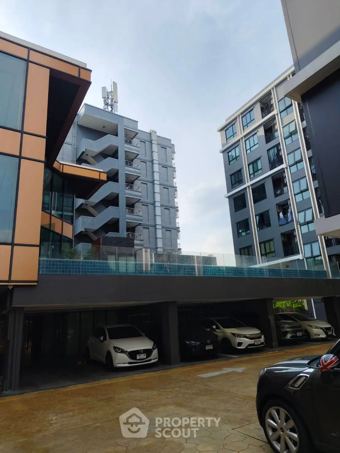 Modern apartment complex with parking and contemporary architecture