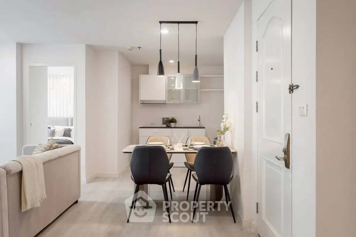 Modern open-plan dining area with sleek kitchen and cozy living space