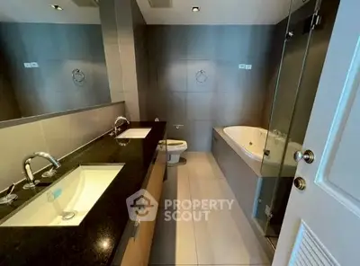 Luxurious modern bathroom with dual sinks and bathtub in sleek design.