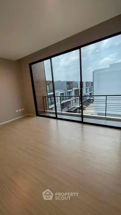 Spacious modern room with large windows and balcony view in upscale property.