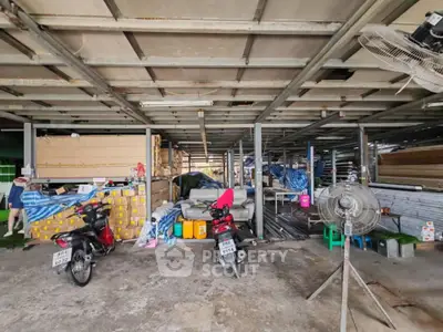 Spacious industrial warehouse with motorbikes and storage materials