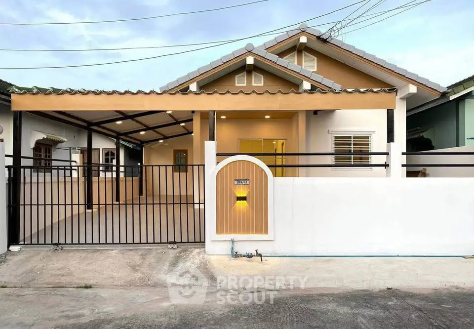 Charming single-story house with gated entrance and covered parking in a serene neighborhood.
