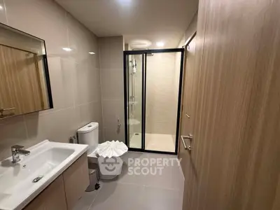 Modern bathroom with sleek fixtures and glass shower enclosure