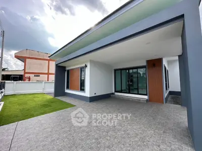 Modern single-story house with spacious driveway and green lawn