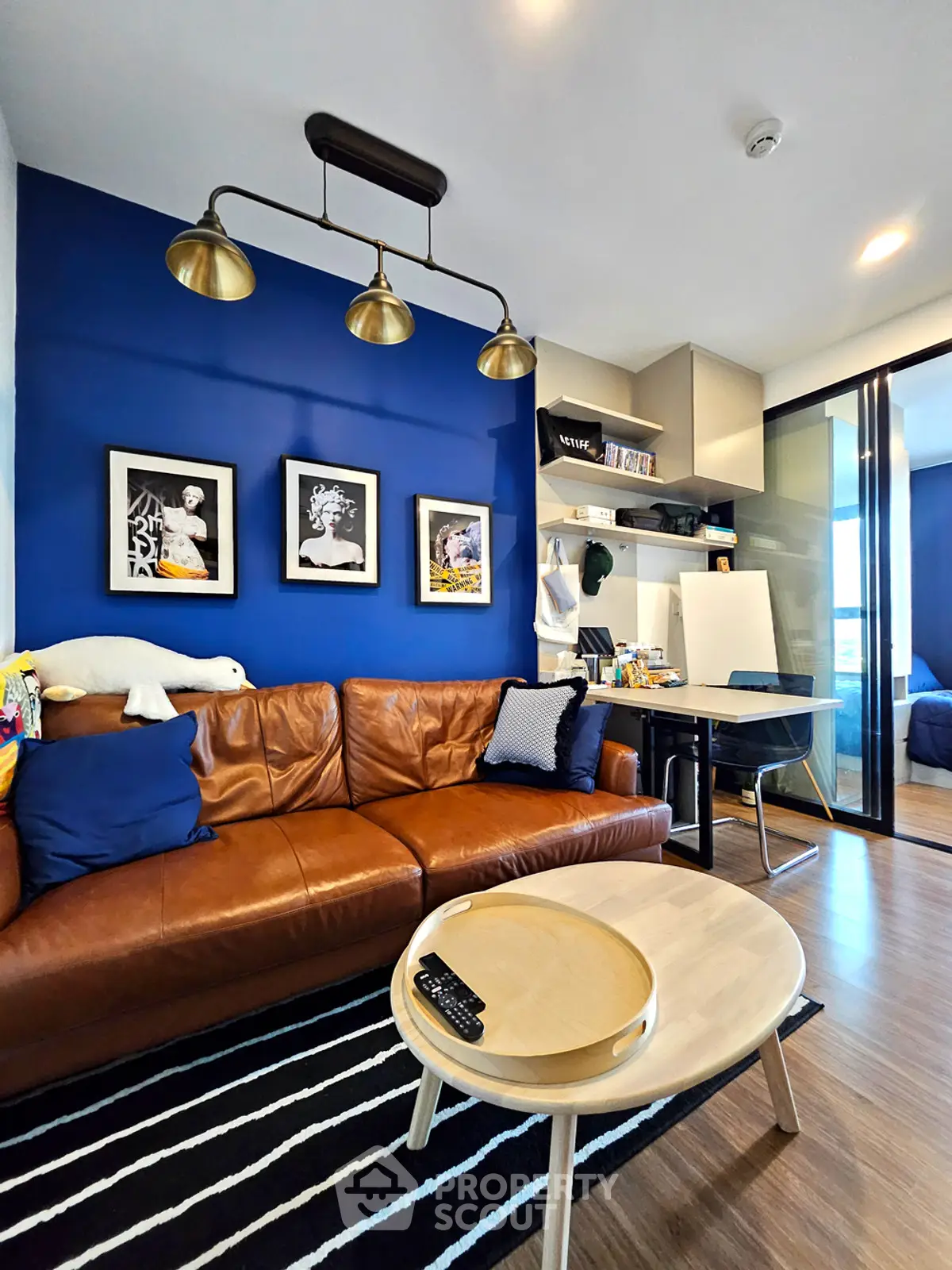 Modern living room with blue accent wall and stylish decor